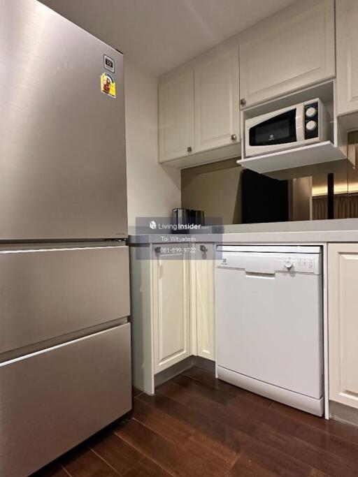 Modern kitchen with stainless steel refrigerator, built-in microwave, and dishwasher