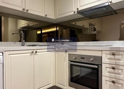 Modern kitchen with beige cabinetry and stainless steel appliances