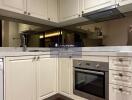 Modern kitchen with beige cabinetry and stainless steel appliances