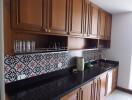 Spacious kitchen with wooden cabinets and patterned backsplash