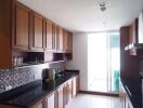 Modern kitchen with wooden cabinets and black granite countertops