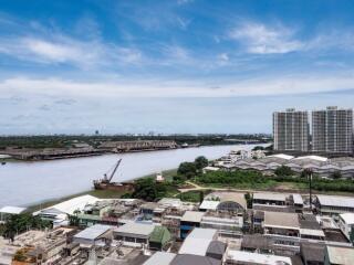 Aerial view of a riverside with buildings and a clear blue sky