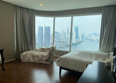 Bedroom with large windows and urban view