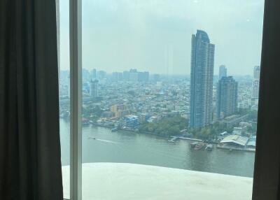 Bedroom with large window and city view