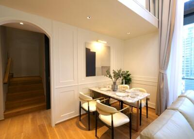 Modern dining area adjacent to staircase