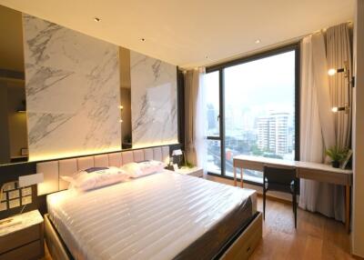 Modern bedroom with large window and city view