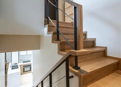 Modern wooden staircase with metal railings