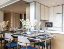 Modern dining area with glass table and blue chairs