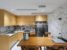 Modern kitchen with wooden cabinets and a dining area.