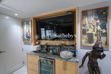 Modern kitchenette with artwork and built-in appliances