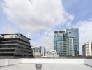 Cityscape view with modern buildings under a partly cloudy sky