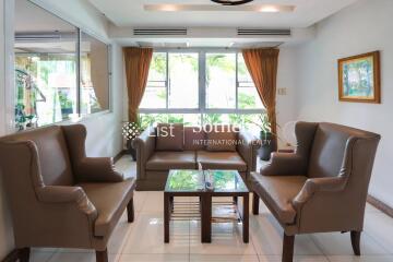 Elegant living room with a seating area including sofas and armchairs.