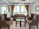 Elegant living room with a seating area including sofas and armchairs.