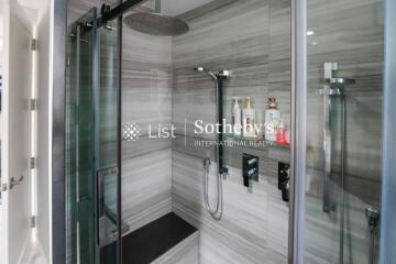 Modern bathroom with glass shower enclosure and built-in shelf