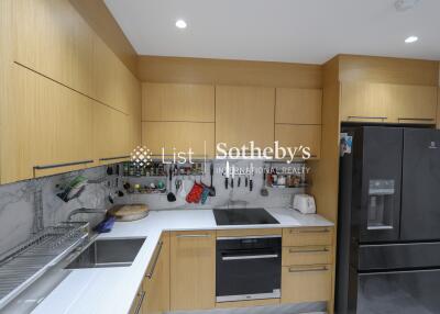 Modern kitchen with wooden cabinets and black appliances