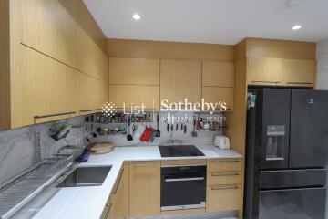 Modern kitchen with wooden cabinets and black appliances