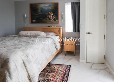 Spacious bedroom with a large bed and wall art