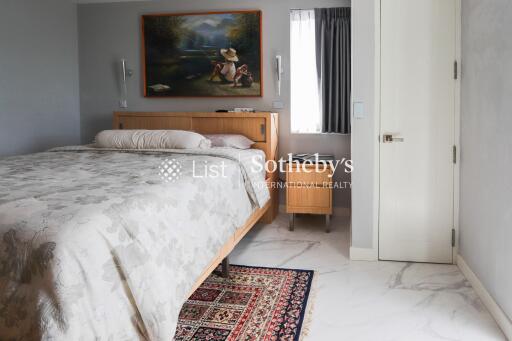 Spacious bedroom with a large bed and wall art