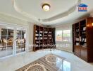 Spacious living room with bookshelves and ample natural light