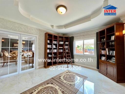 Spacious living room with bookshelves and ample natural light