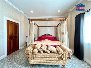 Elegant, fully-furnished bedroom with canopy bed and luxurious decor