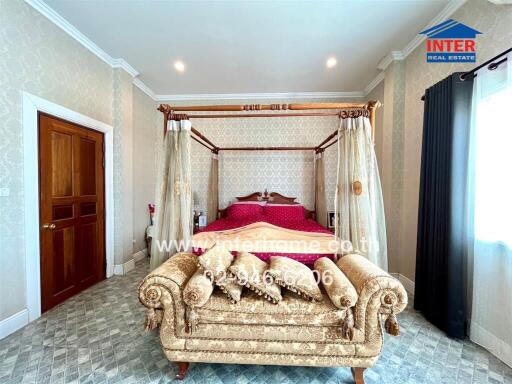 Elegant, fully-furnished bedroom with canopy bed and luxurious decor