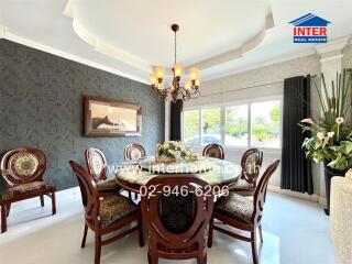 Elegant dining room with ornate wooden dining set and chandelier