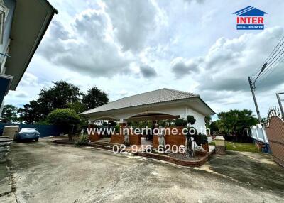 Outdoor view of the property with a carport, driveway, and garden