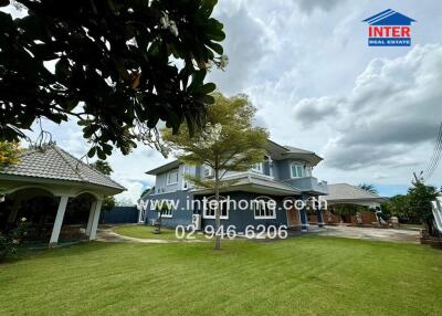 Exterior view of a residential property with a spacious lawn