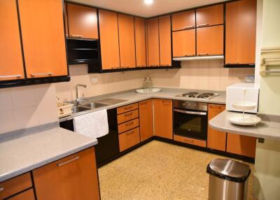 Modern kitchen with wooden cabinets and stainless steel appliances