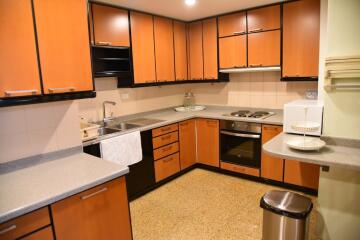 Modern kitchen with wooden cabinets and stainless steel appliances