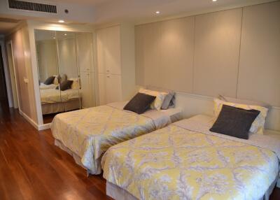 modern bedroom with twin beds and mirrored closet