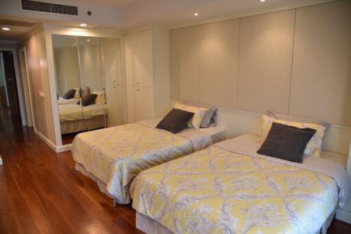 modern bedroom with twin beds and mirrored closet