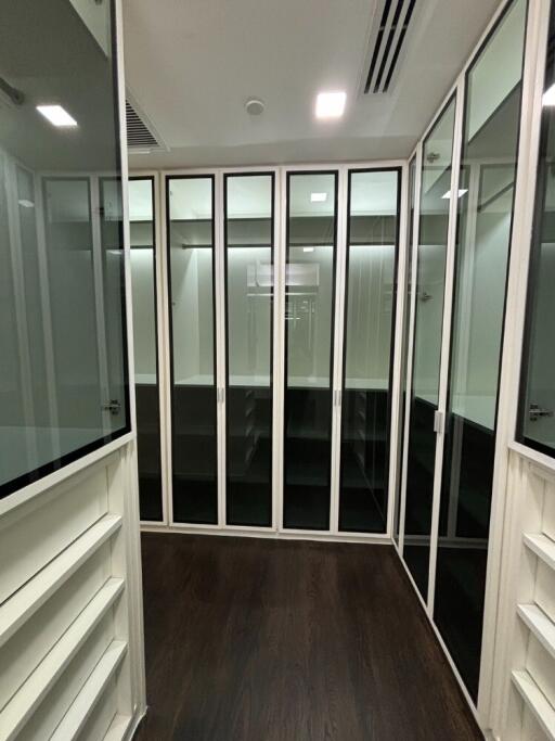 Spacious walk-in closet with sliding glass doors