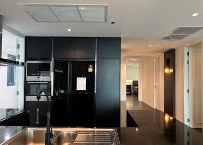 Modern kitchen with black appliances and open view to living area