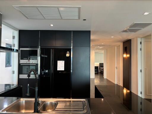 Modern kitchen with black appliances and open view to living area