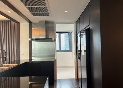 Modern kitchen with black cabinetry and stainless steel appliances