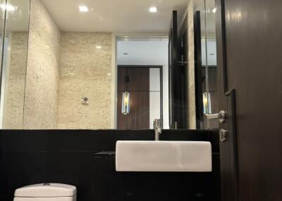 Modern bathroom with mirror wall and sleek fixtures