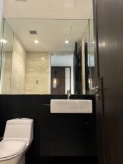 Modern bathroom with mirror wall and sleek fixtures