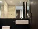 Modern bathroom with mirror wall and sleek fixtures