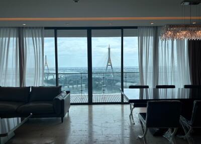 Living room with a view of a bridge through large glass doors