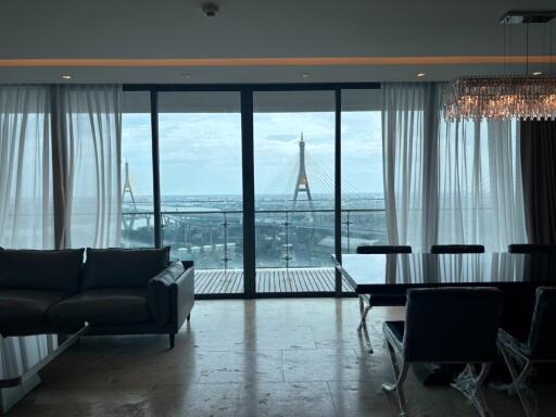 Living room with a view of a bridge through large glass doors