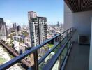 City view from a balcony with railings and air conditioning unit