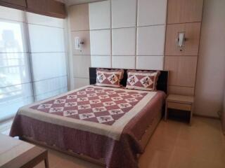 Bedroom with double bed, modern decor, and large window