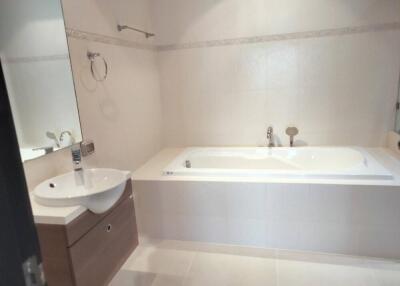 Bathroom with large bathtub and sink