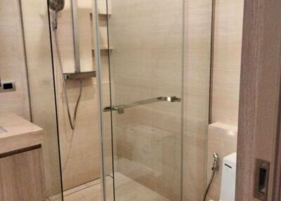 Modern bathroom with glass shower enclosure and toilet