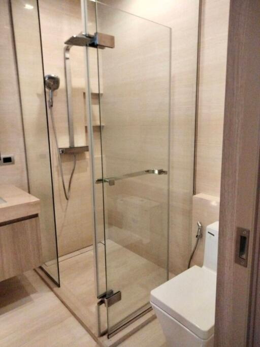 Modern bathroom with glass shower enclosure and toilet