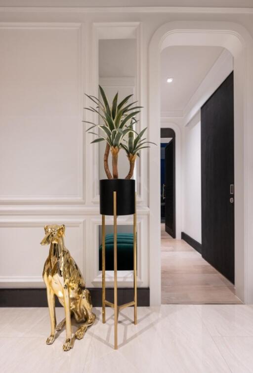 Hallway with decorative plant and golden dog statue