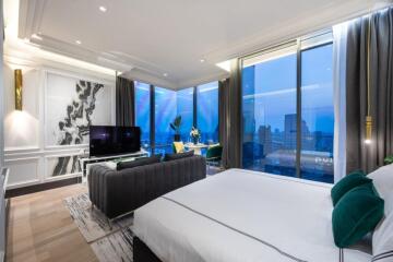 Spacious modern bedroom with large windows and city view