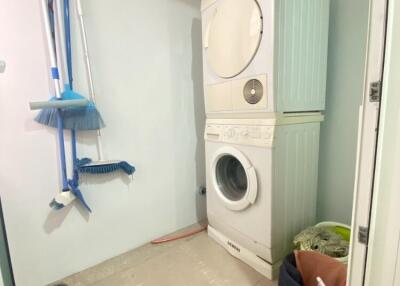 Laundry room with stacked washer and dryer